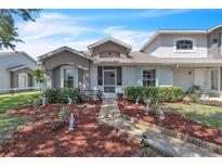 Charming townhome with a meticulously landscaped front yard and a welcoming walkway at 14650 Laguna Beach Cir, Orlando, FL 32824