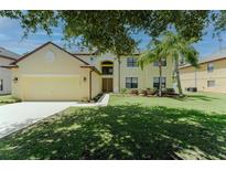 Charming two-story home featuring mature trees, lush lawn and a two car garage at 1778 Waterside Oaks Dr, Orange City, FL 32763