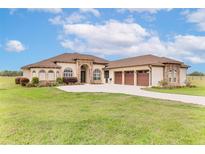 A charming home with a well-manicured lawn and a three-car garage at 35651 Huff Rd, Eustis, FL 32736