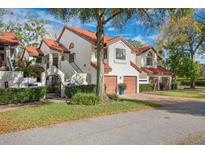 Charming two-story townhome with red tile roof, arched entrance and two-car garage at 546 Via Fontana Dr # 203, Altamonte Springs, FL 32714