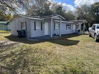 Cozy single-story home with a front porch, a compact yard, and off-street parking at 767 Willie Mays Pkwy, Orlando, FL 32811