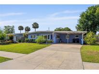 Charming single-story home featuring a covered carport, well-maintained lawn, and mature landscaping at 808 Malone Dr, Orlando, FL 32810