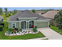 Inviting single-story home with a well-manicured lawn and colorful flower beds enhancing its curb appeal at 12289 Prairie Plantation Way, Orlando, FL 32824