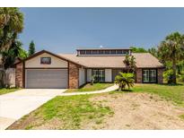 Charming single-Gathering home featuring a two-car garage and well-maintained front yard in a sunny neighborhood at 140 Margate Mews, Longwood, FL 32779