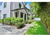 Stunning two-story home with a manicured lawn, lush landscaping, and a welcoming walkway at 1429 Indiana Ave, Winter Park, FL 32789
