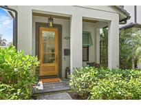 Inviting front entry features a glass door, brick walkway, and lantern lighting at 1429 Indiana Ave, Winter Park, FL 32789