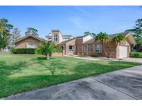 Charming brick home with well-manicured lawn and beautiful landscaping details at 169 Mallard Ln, Daytona Beach, FL 32119