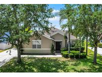 Charming one-story home with lush landscaping, mature trees, and a well-manicured lawn at 2024 Beardsley Dr, Apopka, FL 32703