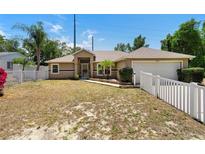 Charming home featuring a well-maintained lawn and a welcoming front entrance at 2074 S Parkton Dr, Deltona, FL 32725