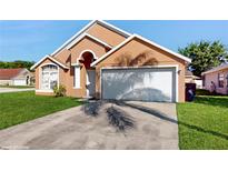 Charming single-Gathering home with a two-car garage and well-maintained lawn at 2108 Shannon Lakes Blvd, Kissimmee, FL 34743