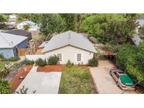 Charming single-story home with a well-maintained front yard, cozy carport, and paved basketball area at 2825 Mayer St, Orlando, FL 32806
