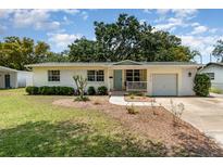 Charming single-story home featuring a well-manicured lawn, light yellow paint, and an inviting front porch at 3416 Grant Blvd, Orlando, FL 32804