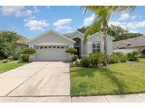 Charming single-story home with manicured lawn, lush landscaping, and a two-car garage at 491 Freeman St, Longwood, FL 32750
