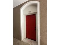 Apartment 132 features a red front door with an arched entrance at 7147 Yacht Basin # 132, Orlando, FL 32835