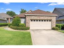 Charming single-story brick home with a two-car garage and well-manicured landscaping at 842 Bentley Green Cir, Winter Springs, FL 32708
