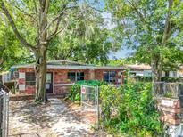 Charming single-story brick home with mature landscaping, gated yard, and inviting entryway at 1263 Dunbar St, Altamonte Springs, FL 32701