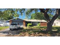 Charming single-story home with a two-car garage and mature landscaping at 1985 Japonica Rd, Winter Park, FL 32792