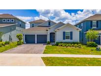 Charming single-Gathering home with a brick driveway and a well-maintained lawn at 2591 Seagirt Way, Clermont, FL 34711