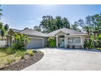 Charming home featuring a well-manicured lawn, an attached garage, and inviting curb appeal at 2623 Gables Dr, Eustis, FL 32726