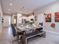 Bright dining room featuring a concrete table, unique seating, and modern decor at 2660 Sunrise Shores Dr, Kissimmee, FL 34747