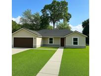 Charming one-story home featuring a well-manicured lawn and inviting entrance at 3082 Se 140Th Ln, Summerfield, FL 34491