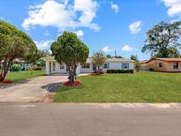 Charming single-story home with well-manicured lawn and mature trees at 413 5Th S St, Dundee, FL 33838