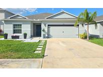 Charming single-story home featuring a well-manicured lawn and a two-car garage, located in a friendly neighborhood at 542 Pine Tree Bridge Trl, St Cloud, FL 34772
