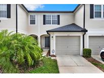 Charming townhome featuring a well-maintained lawn and attached single car garage at 6201 Goethe St # 103, Orlando, FL 32835