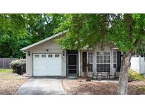 Charming single-story home with well-maintained lawn, garage, and inviting front porch at 10255 Cody Ln, Orlando, FL 32825