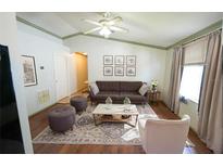 Bright living room with neutral tones, a ceiling fan, hardwood floors, and decor at 10255 Cody Ln, Orlando, FL 32825