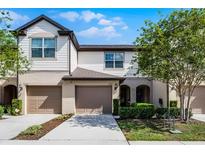 Inviting townhome with a two-car garage and beautifully landscaped front yard at 1109 Pavia Dr, Apopka, FL 32703