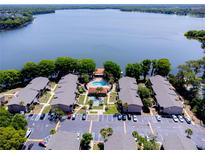 Beautiful aerial view of condo buildings and community pool on the lake at 1163 Paseo Del Mar # B, Casselberry, FL 32707