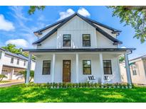 Charming two-story home featuring a covered front porch and well-maintained landscaping at 1321 Weber St, Orlando, FL 32803