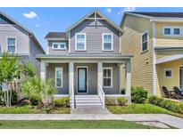 Charming two-story home featuring a welcoming front porch with classic columns and well-maintained landscaping at 13913 Hahn Ln, Orlando, FL 32827