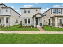 Charming two-story home with manicured lawn and inviting front porch, perfect for suburban living at 16460 Silver Brook Way, Winter Garden, FL 34787