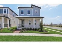 Charming two-story home featuring a covered front porch and nicely manicured landscaping at 16544 Silver Brook Way, Winter Garden, FL 34787