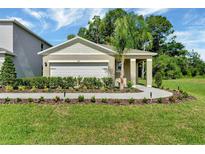 Charming single-story home featuring a two-car garage and beautifully landscaped front yard at 1842 Waggoner St, Kissimmee, FL 34744