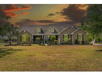 Charming single-story home with well-manicured lawn, inviting front porch, and verdant landscaping at 19204 Paddock St, Orlando, FL 32833
