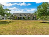 Charming single-Gathering home featuring a well-maintained lawn, mature trees, and a welcoming entrance at 19204 Paddock St, Orlando, FL 32833