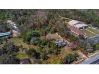 Large parcel of land outlined in red with mature trees ready for new construction or redevelopment at 2214 Rouse Rd, Orlando, FL 32817