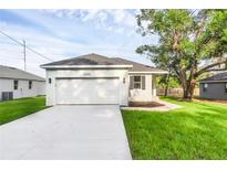 Charming single-story home with a two-car garage, fresh landscaping, and a well-manicured lawn at 31830 Sybil Ave, Sorrento, FL 32776