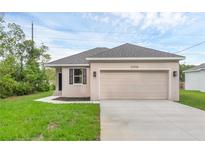 Charming single-story home featuring a two-car garage, well-maintained lawn, and neutral exterior paint at 31836 Sybil Ave, Sorrento, FL 32776