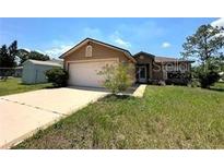 Charming single-story home with a two-car garage, well-maintained lawn, and inviting curb appeal at 440 Martigues Dr, Kissimmee, FL 34759