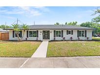 Charming single-story home featuring a well-manicured lawn, clean lines, and modern curb appeal at 4804 Oakbrooke Pl, Orlando, FL 32812