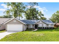 Charming single-story home with a well-maintained lawn and attached two-car garage at 717 Pine Ter, Altamonte Springs, FL 32714