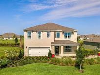 Beautiful two-story home featuring a manicured front yard and an attached two-car garage at 1890 Walnut Creek Dr, Kissimmee, FL 34744