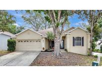 Charming single-story home featuring a manicured lawn, two-car garage, and inviting front entrance at 2468 Cimmaron Ash Way, Apopka, FL 32703