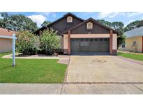 Charming single-Gathering home with well-maintained lawn and two car garage at 2656 Whisper Lakes Club Cir, Orlando, FL 32837