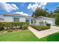 Charming single-story home with well-maintained landscaping, green lawn and sidewalk at 2745 University Acres Dr, Orlando, FL 32817