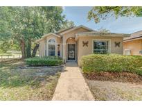 Charming single-story home featuring manicured landscaping and a welcoming walkway at 289 N Wilderness Pt, Casselberry, FL 32707
